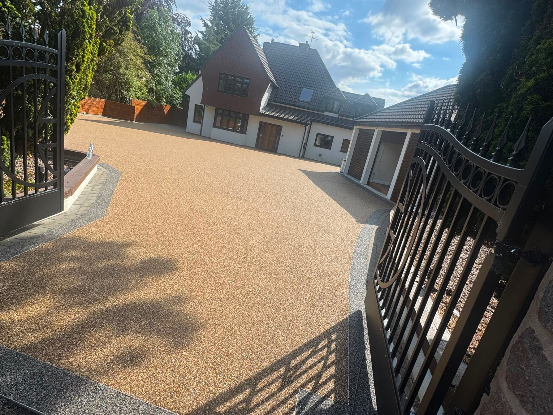 Gold resin bound gated driveway with a block paved border, Gloucester