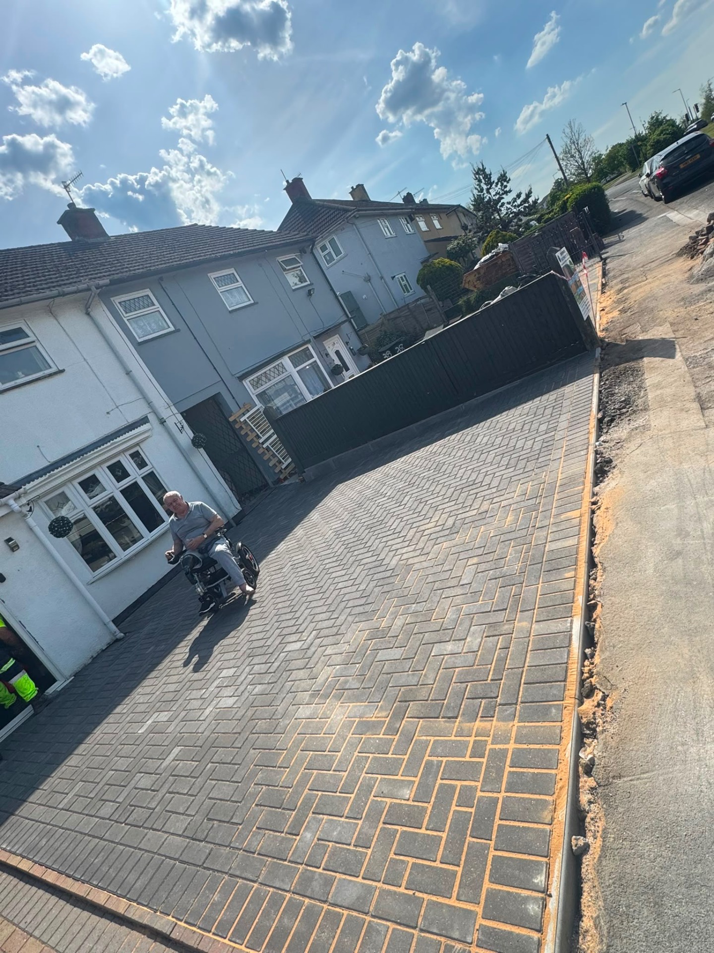 Wide grey herringbone block paved driveway with a step-free frontage, completed in Gloucester